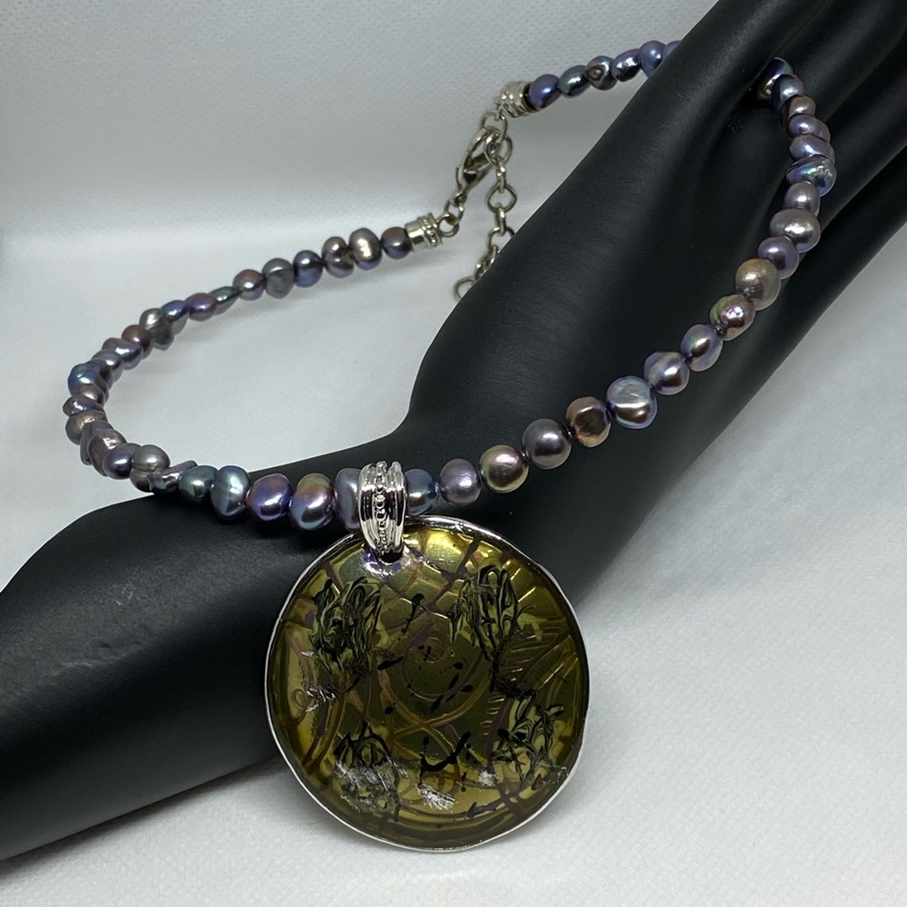 Faux pearls necklace with bold pendant.